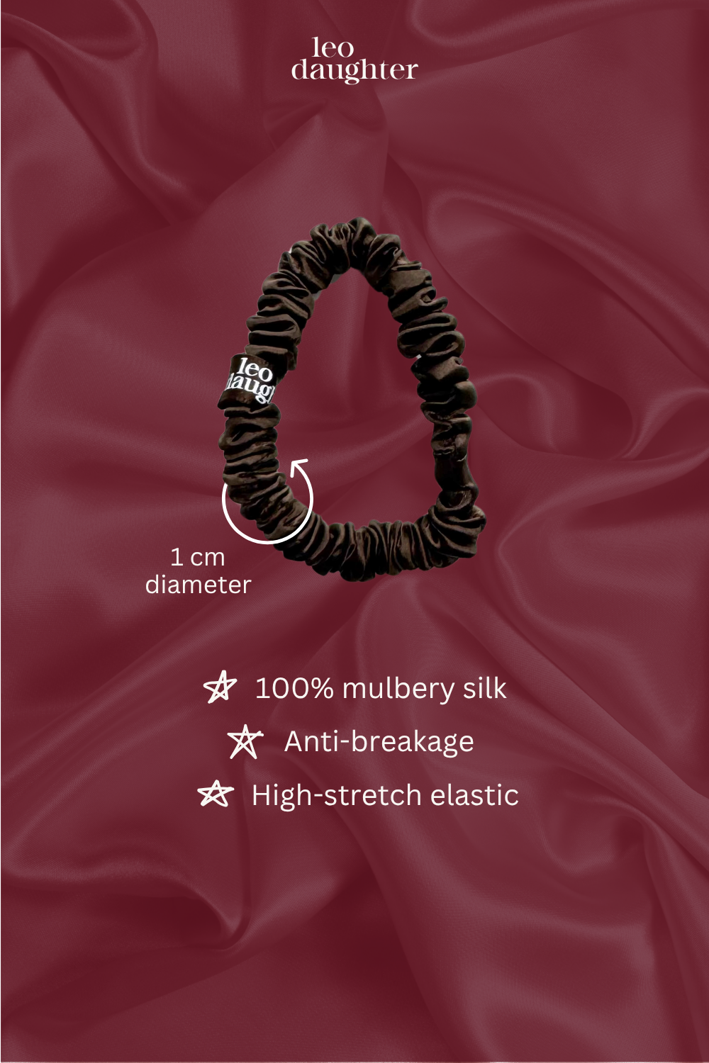 Brown silk scrunchie with product details on a red satin background