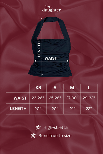 Black halter top with measurement chart on a red fabric background